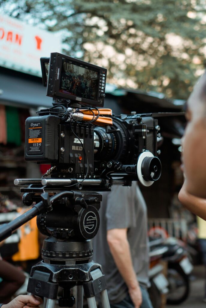 pexels-photo-3062553-3062553 Close-up of professional video camera and crew on an outdoor film set.